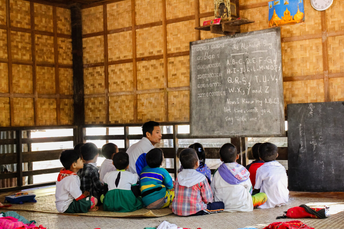 Teacher working with children in a rural classroom